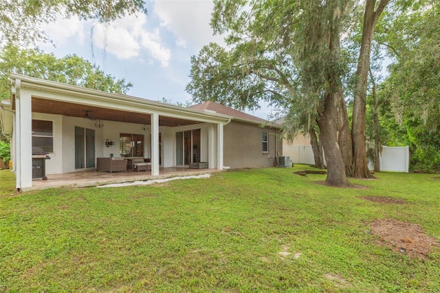 228 Taylor Bay Ln, Brandon, FL 33510 - back of house featuring a patio, stucco siding, and an outdoor living space