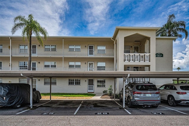 970 Virginia St Unit 109, Dunedin, FL 34698 - view of property featuring covered parking
