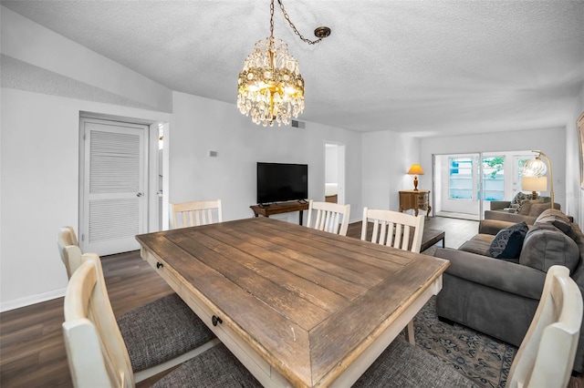 970 Virginia St Unit 109, Dunedin, FL 34698 - dining area with a chandelier, dark wood-style flooring, and a textured ceiling