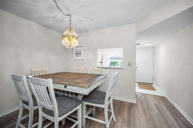 970 Virginia St Unit 109, Dunedin, FL 34698 - dining area with wood finished floors and a chandelier