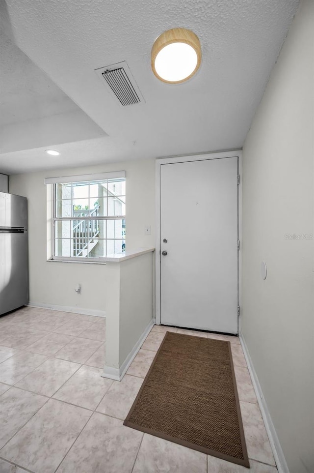 970 Virginia St Unit 109, Dunedin, FL 34698 - doorway featuring a textured ceiling and light tile patterned floors