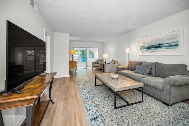 970 Virginia St Unit 109, Dunedin, FL 34698 - living area featuring wood finished floors and a textured ceiling