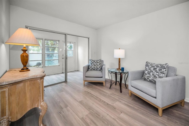 970 Virginia St Unit 109, Dunedin, FL 34698 - sitting room with light wood finished floors and baseboards