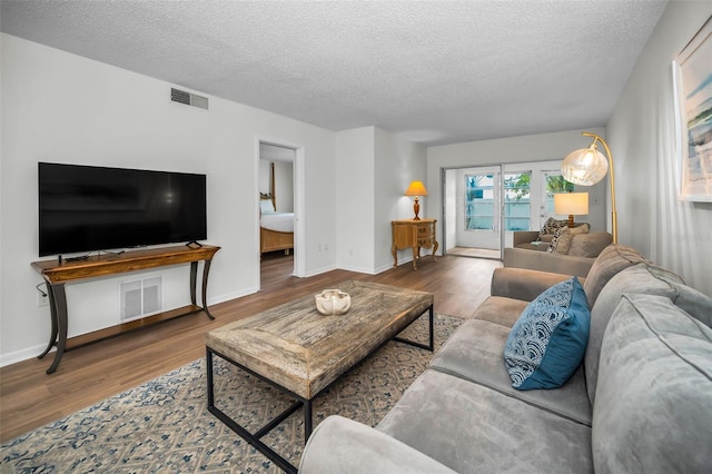 970 Virginia St Unit 109, Dunedin, FL 34698 - living room featuring wood finished floors and a textured ceiling