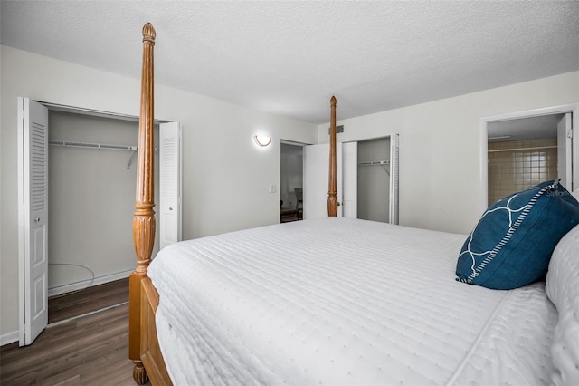 970 Virginia St Unit 109, Dunedin, FL 34698 - bedroom with wood finished floors, two closets, and a textured ceiling