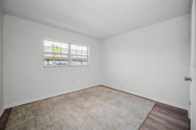 970 Virginia St Unit 109, Dunedin, FL 34698 - unfurnished room with wood finished floors and baseboards