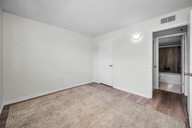 970 Virginia St Unit 109, Dunedin, FL 34698 - unfurnished bedroom with wood finished floors and baseboards