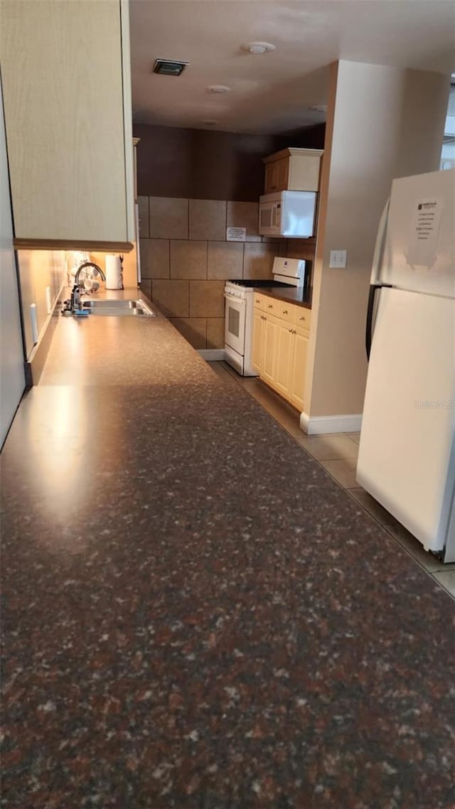 4215 E Bay Dr Unit 1805B, Clearwater, FL 33764 - kitchen featuring white appliances, tasteful backsplash, and dark countertops