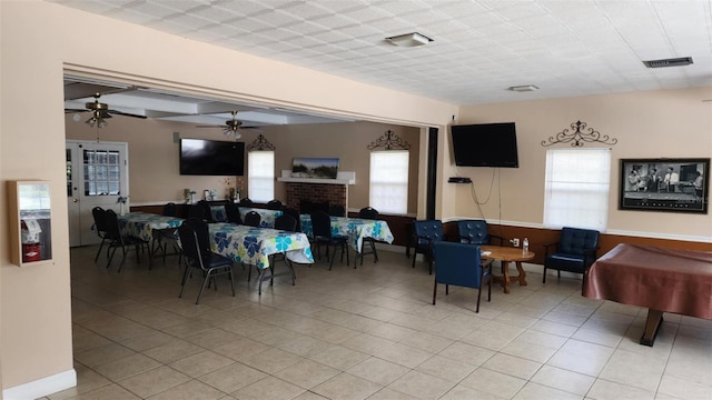 4215 E Bay Dr Unit 1805B, Clearwater, FL 33764 - dining space with a ceiling fan, light tile patterned floors, and a fireplace