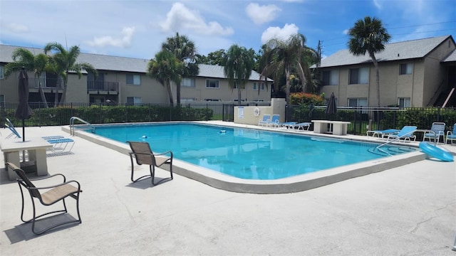 4215 E Bay Dr Unit 1805B, Clearwater, FL 33764 - community pool featuring a patio area and a residential view