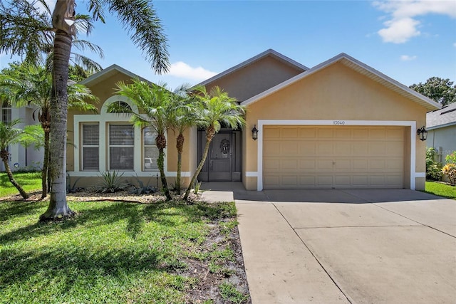 13040 Waterbourne Dr, Gibsonton, FL 33534 - single story home featuring stucco siding, driveway, a garage, and a front lawn