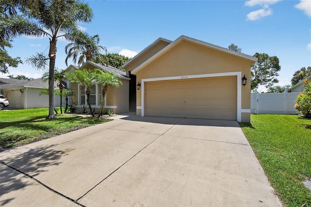 13040 Waterbourne Dr, Gibsonton, FL 33534 - ranch-style house featuring stucco siding, concrete driveway, and an attached garage