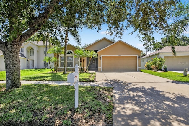 13040 Waterbourne Dr, Gibsonton, FL 33534 - ranch-style house with an attached garage, concrete driveway, stucco siding, and a front yard
