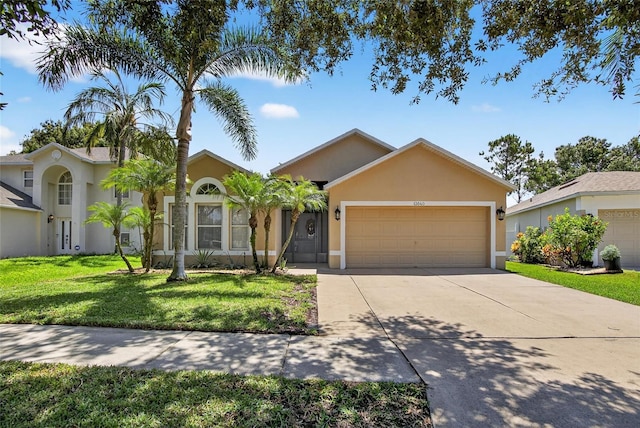 13040 Waterbourne Dr, Gibsonton, FL 33534 - ranch-style home featuring stucco siding, a garage, a front yard, and driveway