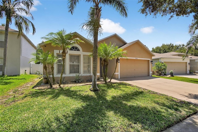 13040 Waterbourne Dr, Gibsonton, FL 33534 - single story home with an attached garage, stucco siding, and driveway