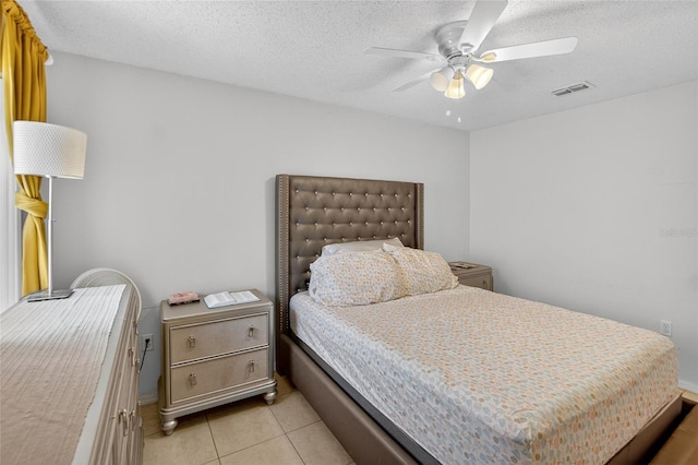 13040 Waterbourne Dr, Gibsonton, FL 33534 - bedroom with a textured ceiling, light tile patterned flooring, and a ceiling fan