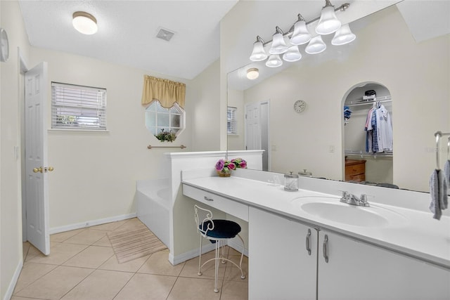 13040 Waterbourne Dr, Gibsonton, FL 33534 - full bathroom with vanity, a bath, tile patterned flooring, lofted ceiling, and a spacious closet