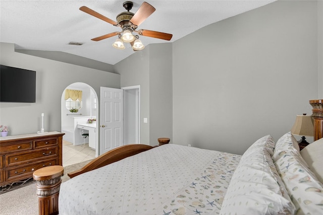 13040 Waterbourne Dr, Gibsonton, FL 33534 - bedroom featuring vaulted ceiling, arched walkways, a ceiling fan, and ensuite bathroom