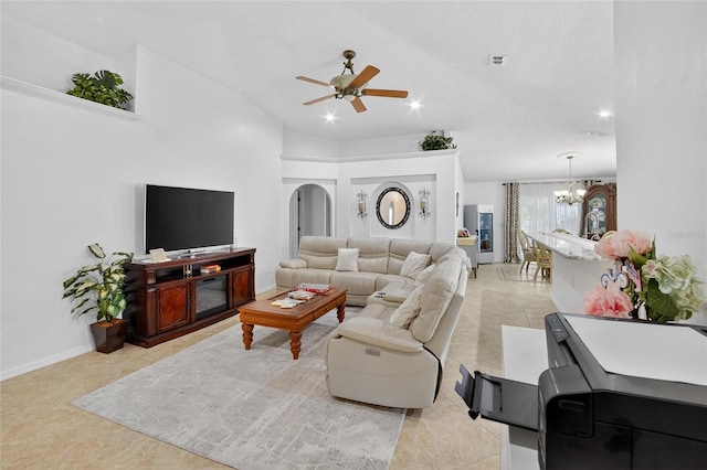 13040 Waterbourne Dr, Gibsonton, FL 33534 - living room featuring vaulted ceiling, ceiling fan, light tile patterned flooring, a chandelier, and arched walkways