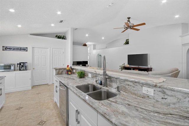 13040 Waterbourne Dr, Gibsonton, FL 33534 - kitchen with lofted ceiling, stainless steel dishwasher, ceiling fan, light stone counters, and open floor plan