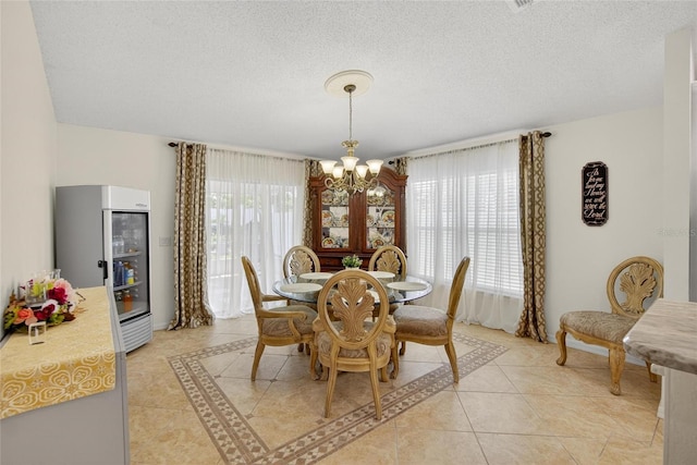 13040 Waterbourne Dr, Gibsonton, FL 33534 - dining room with a chandelier, light tile patterned floors, and a textured ceiling