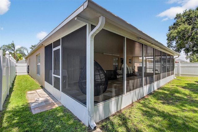 13040 Waterbourne Dr, Gibsonton, FL 33534 - view of side of property with a sunroom and a fenced backyard