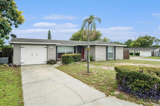 7510 Tyson Dr, Port Richey, FL 34668 - single story home featuring a garage, concrete driveway, and brick siding