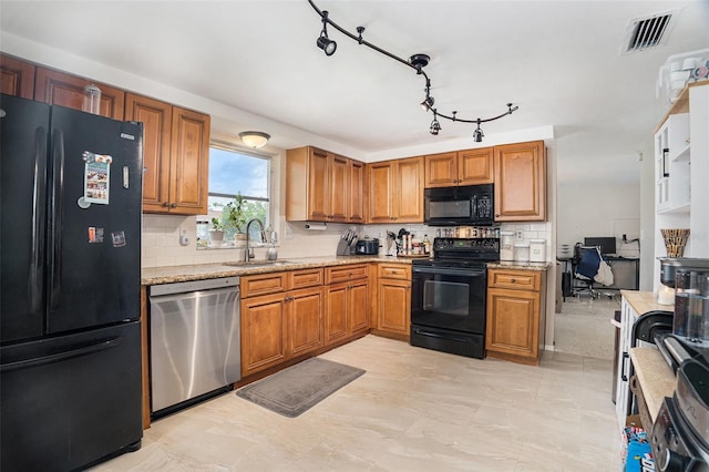 7510 Tyson Dr, Port Richey, FL 34668 - kitchen with black appliances, backsplash, brown cabinets, and light stone countertops