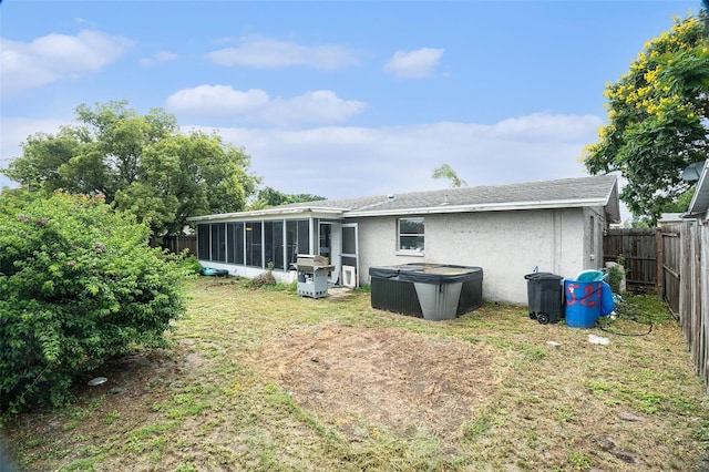 7510 Tyson Dr, Port Richey, FL 34668 - back of property featuring a sunroom, a fenced backyard, and stucco siding