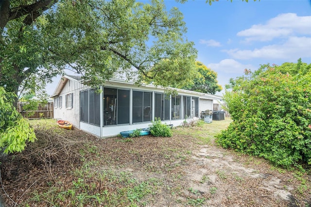 7510 Tyson Dr, Port Richey, FL 34668 - rear view of property featuring a sunroom