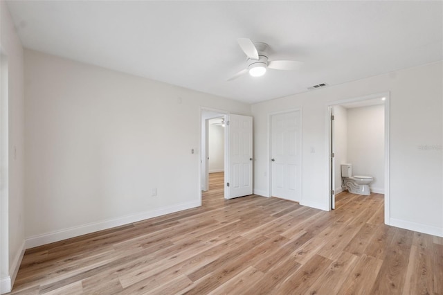 4236 Woodtrail Blvd, New Port Richey, FL 34653 - unfurnished bedroom featuring light wood finished floors, connected bathroom, and a ceiling fan