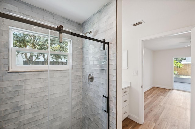4236 Woodtrail Blvd, New Port Richey, FL 34653 - bathroom with healthy amount of natural light, a stall shower, and wood finished floors