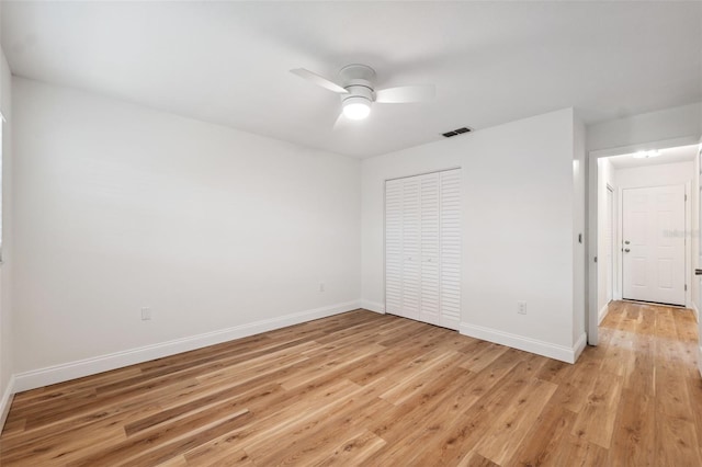 4236 Woodtrail Blvd, New Port Richey, FL 34653 - unfurnished bedroom with light wood-style floors, a closet, and ceiling fan