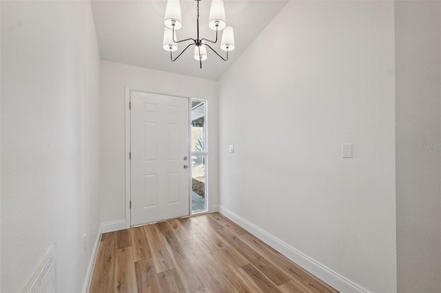 4236 Woodtrail Blvd, New Port Richey, FL 34653 - entrance foyer with a chandelier and light wood finished floors