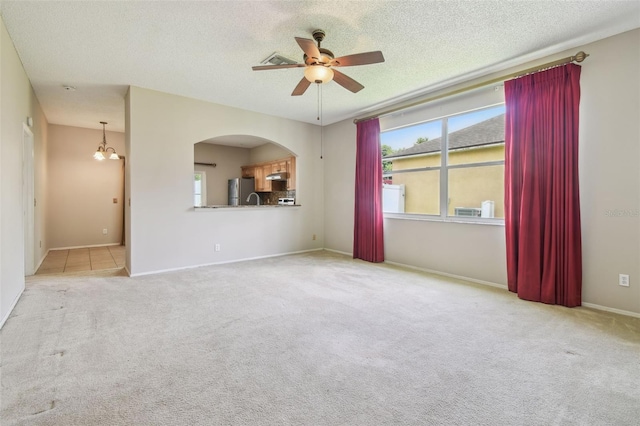 501 Royal Ridge St, Valrico, FL 33594 - empty room featuring a ceiling fan, carpet, arched walkways, and a textured ceiling