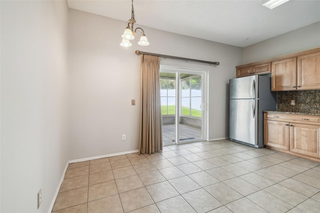 501 Royal Ridge St, Valrico, FL 33594 - kitchen with freestanding refrigerator, light tile patterned flooring, a chandelier, and pendant lighting