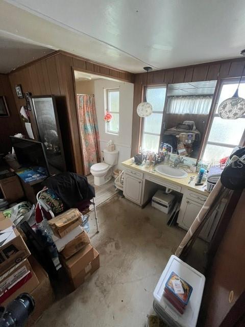 8946 Dream Way, Largo, FL 33773 - full bath featuring vanity and wooden walls