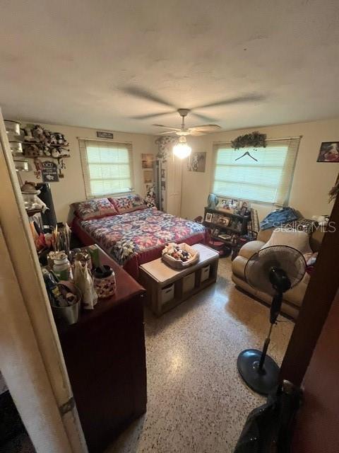 8946 Dream Way, Largo, FL 33773 - bedroom with speckled floor and a ceiling fan