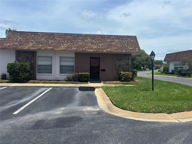 6125 Chesham Dr Unit 1, New Port Richey, FL 34653 - view of building exterior featuring uncovered parking