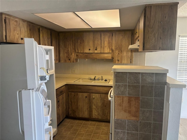 6125 Chesham Dr Unit 1, New Port Richey, FL 34653 - kitchen featuring freestanding refrigerator and brown cabinetry