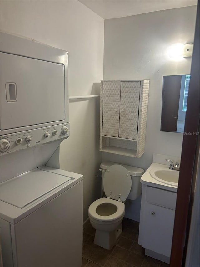 6125 Chesham Dr Unit 1, New Port Richey, FL 34653 - bathroom featuring stacked washer / drying machine, vanity, and tile patterned flooring