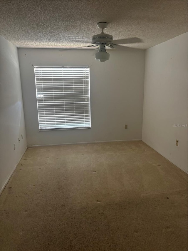 6125 Chesham Dr Unit 1, New Port Richey, FL 34653 - spare room featuring carpet, a ceiling fan, and a textured ceiling