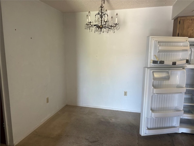 6125 Chesham Dr Unit 1, New Port Richey, FL 34653 - unfurnished dining area with a chandelier, carpet flooring, and a textured ceiling