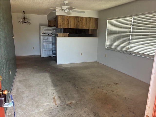 6125 Chesham Dr Unit 1, New Port Richey, FL 34653 - unfurnished living room featuring ceiling fan, carpet flooring, and a textured ceiling