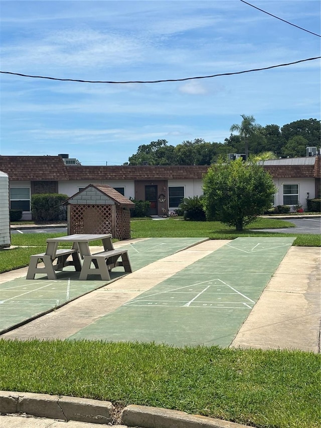 6125 Chesham Dr Unit 1, New Port Richey, FL 34653 - view of home's community featuring shuffleboard and a lawn