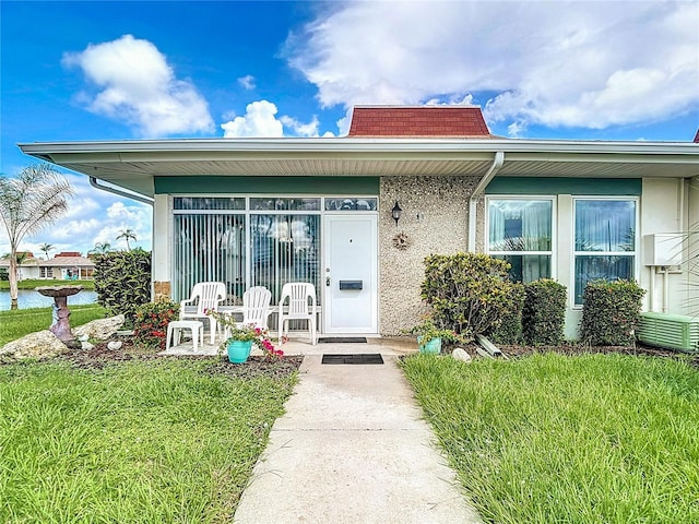 4360 Tahitian Gardens Cir Unit H, Holiday, FL 34691 - property entrance with a porch and a lawn