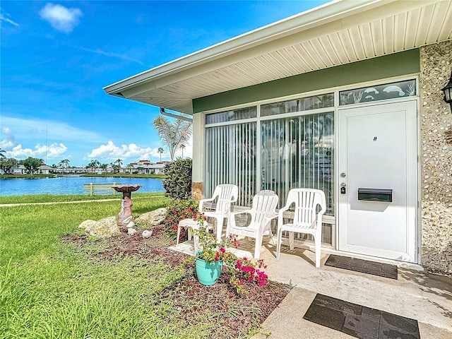 4360 Tahitian Gardens Cir Unit H, Holiday, FL 34691 - property entrance with a water view and a lawn