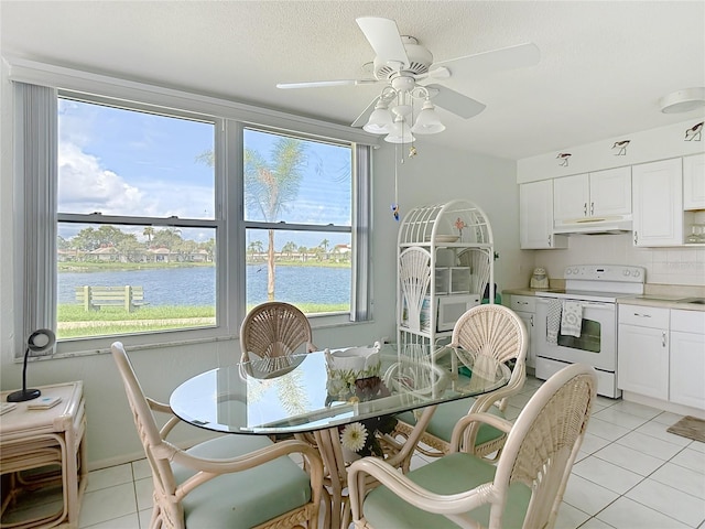 4360 Tahitian Gardens Cir Unit H, Holiday, FL 34691 - dining room with light tile patterned flooring, a water view, and ceiling fan