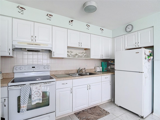 4360 Tahitian Gardens Cir Unit H, Holiday, FL 34691 - kitchen with white appliances, under cabinet range hood, white cabinets, tasteful backsplash, and a textured ceiling
