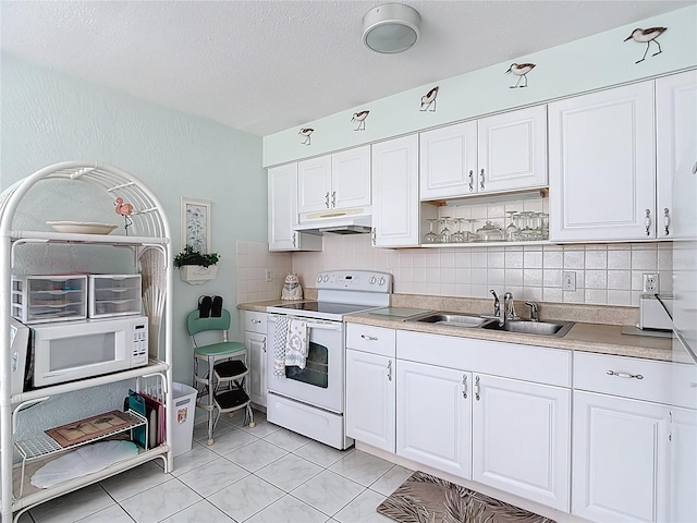 4360 Tahitian Gardens Cir Unit H, Holiday, FL 34691 - kitchen featuring white appliances, under cabinet range hood, white cabinets, and a textured ceiling